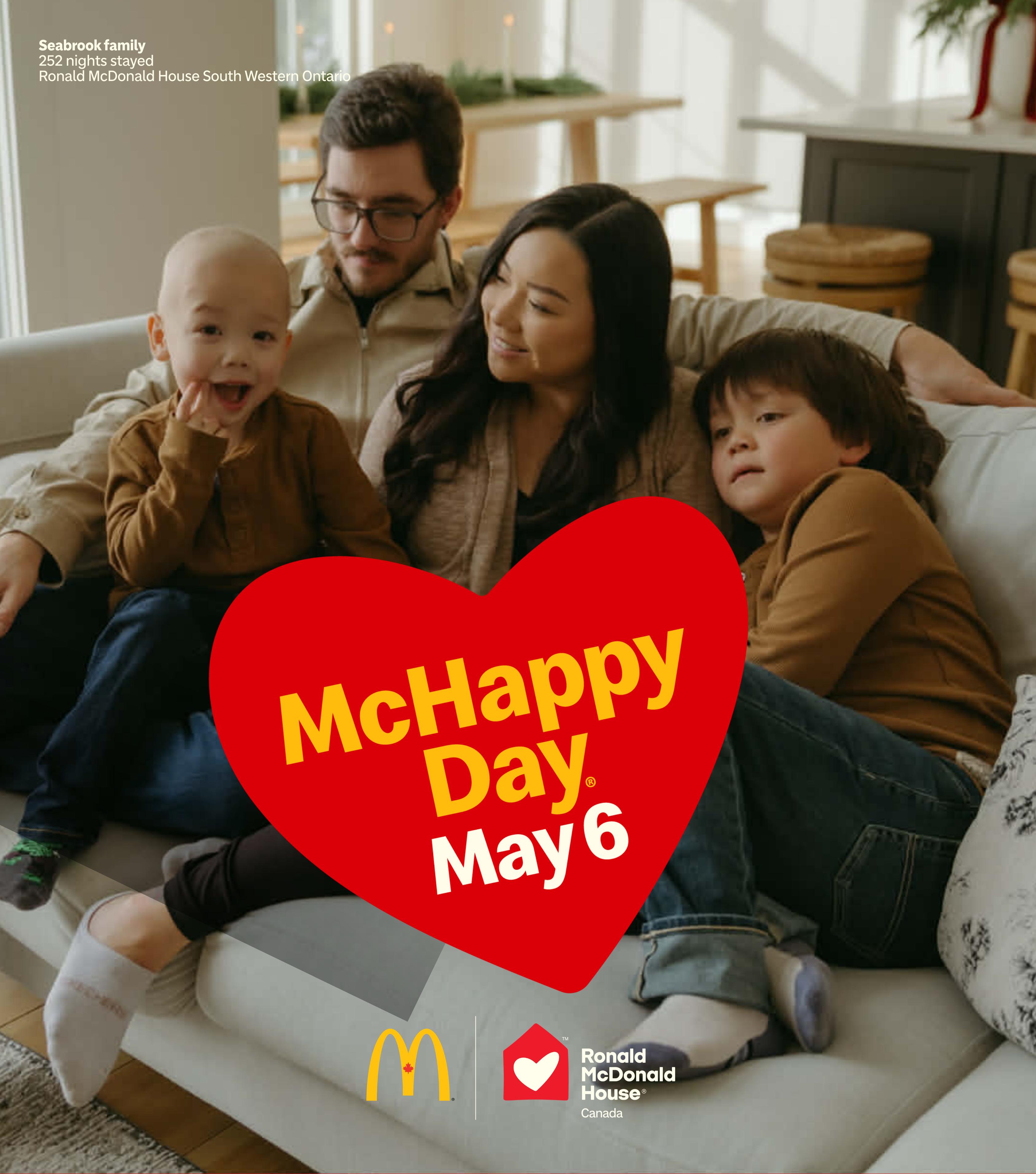 Family seated together on a couch in a bright living room with a red heart graphic reading “McHappy Day, May 6,” with McDonald’s Canada and Ronald McDonald House Canada logos